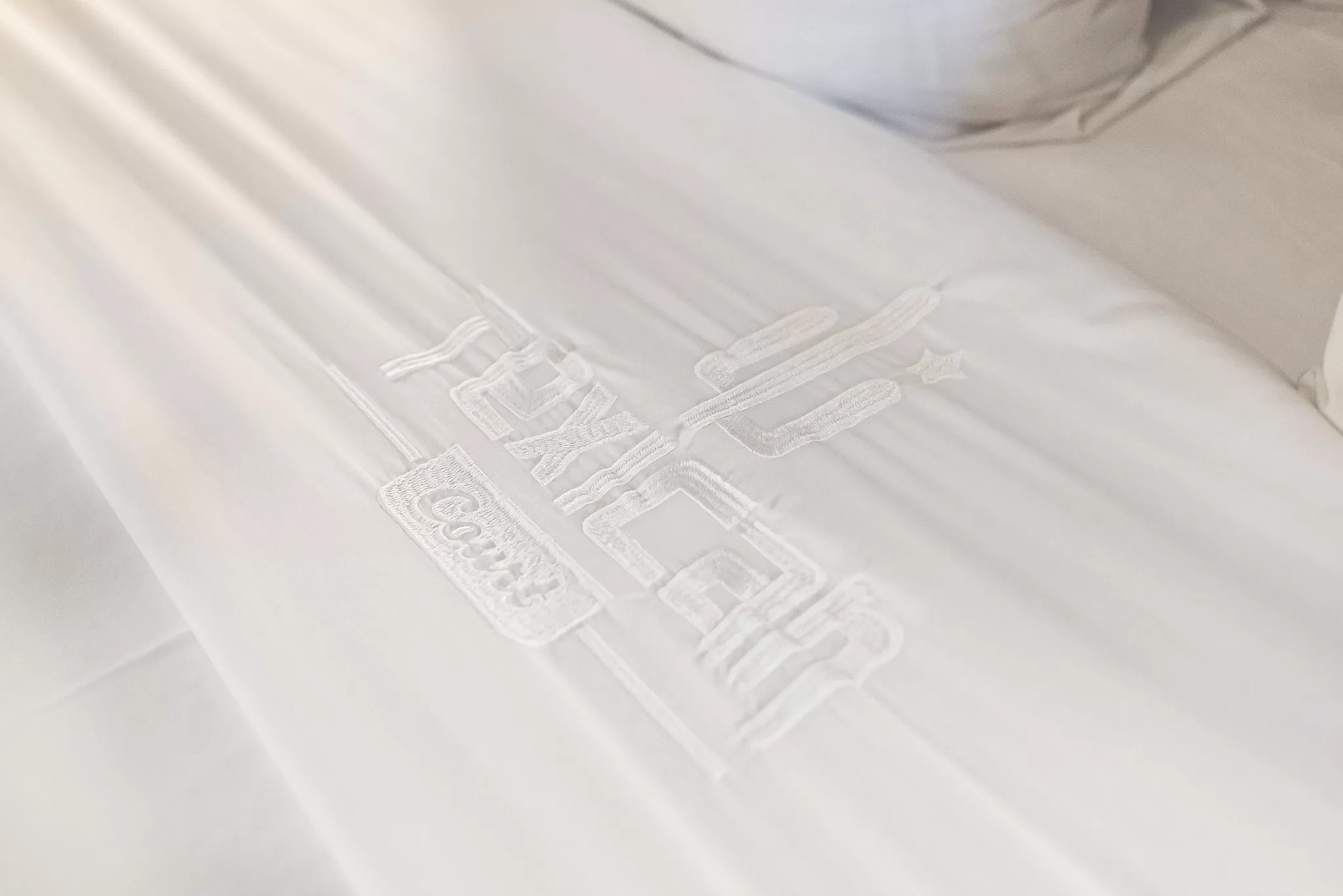 Bedding in a guestroom at the Texican Court Hotel