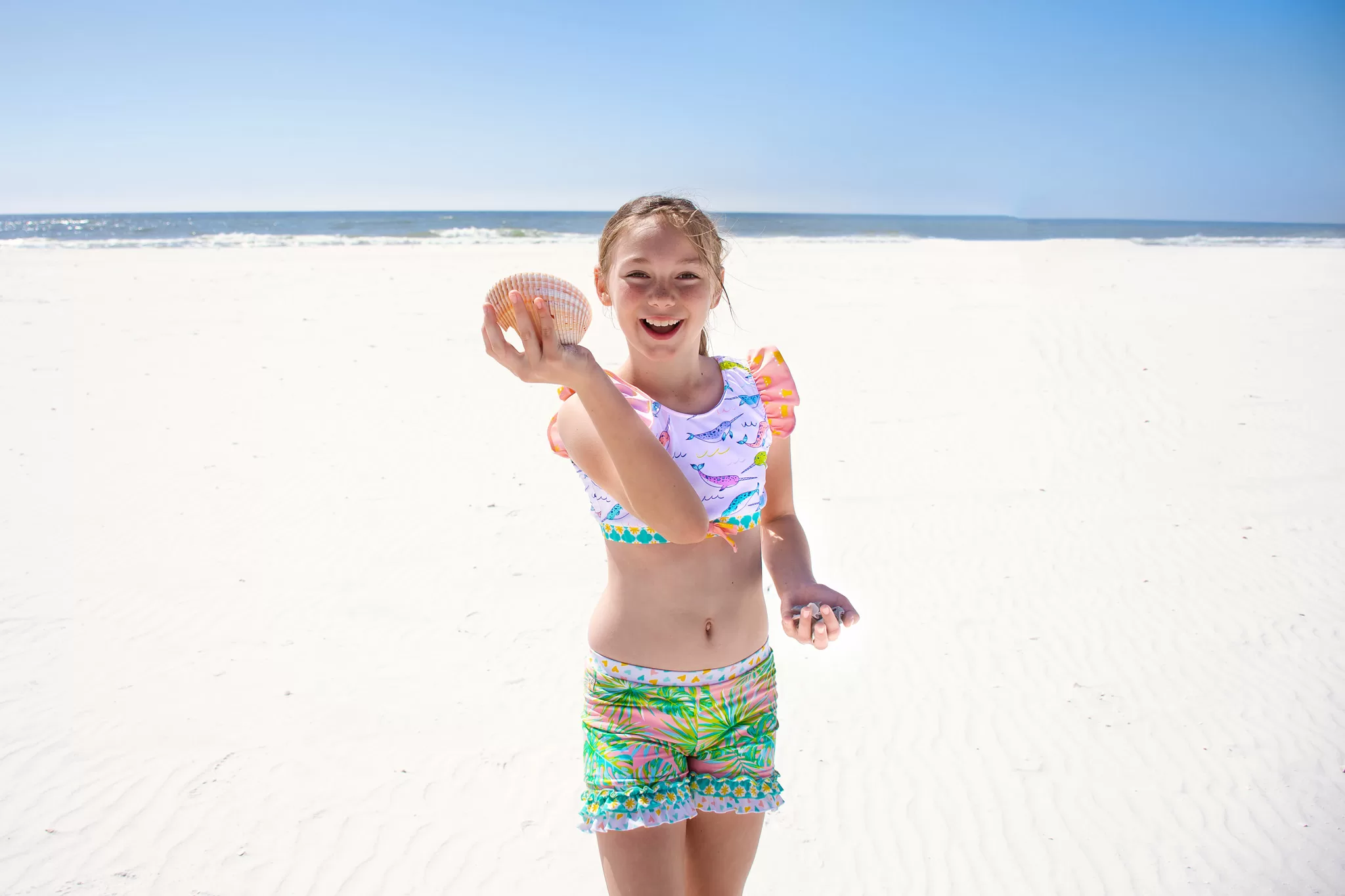 Girl holding a shell at at Shell Island in Panama City Beach