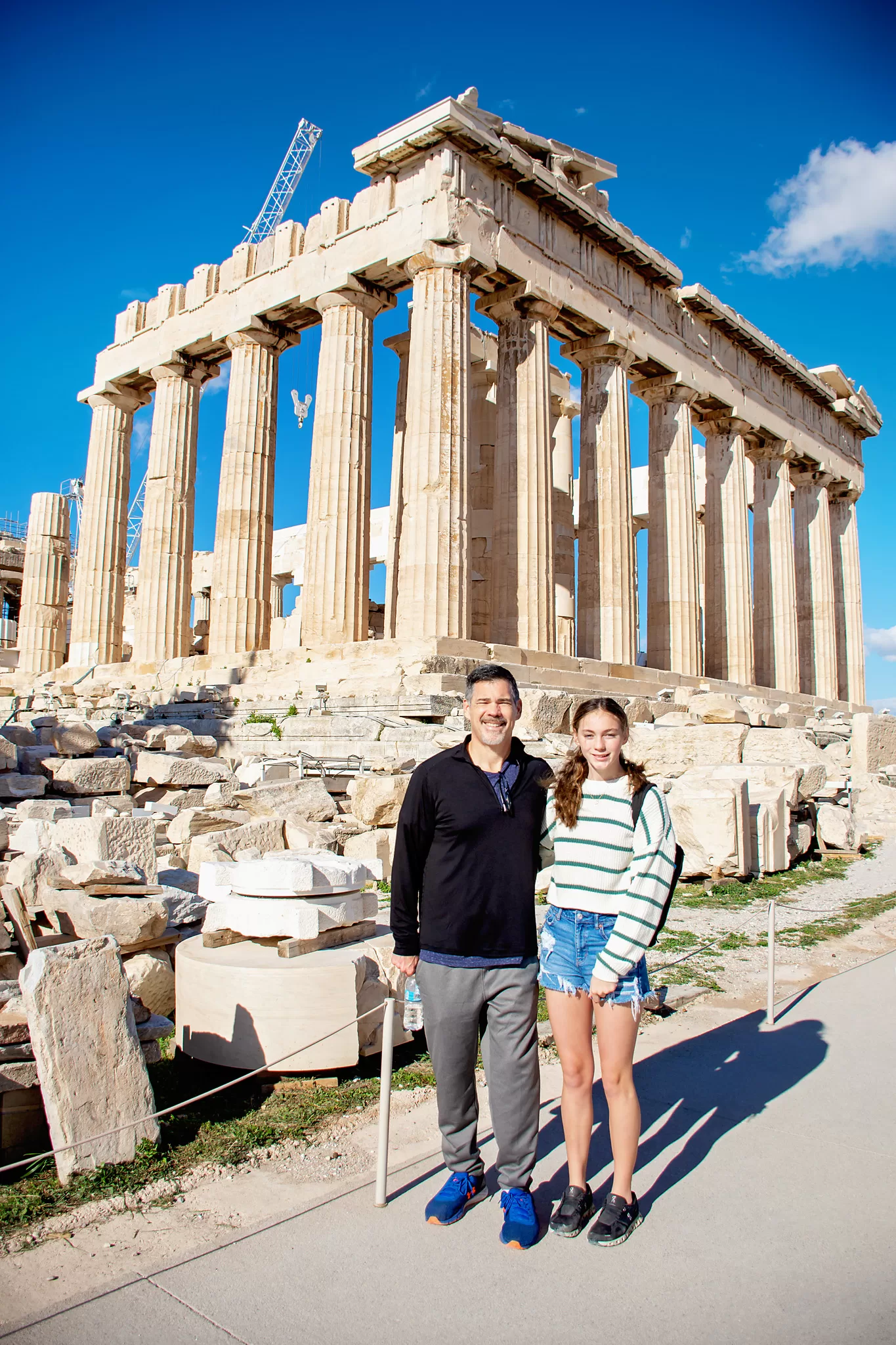 A photo of a father and daughter at the Acropolis.  Both are wearing tennis shoes.  This is a blog post about European Travel Packing Must Have items. 