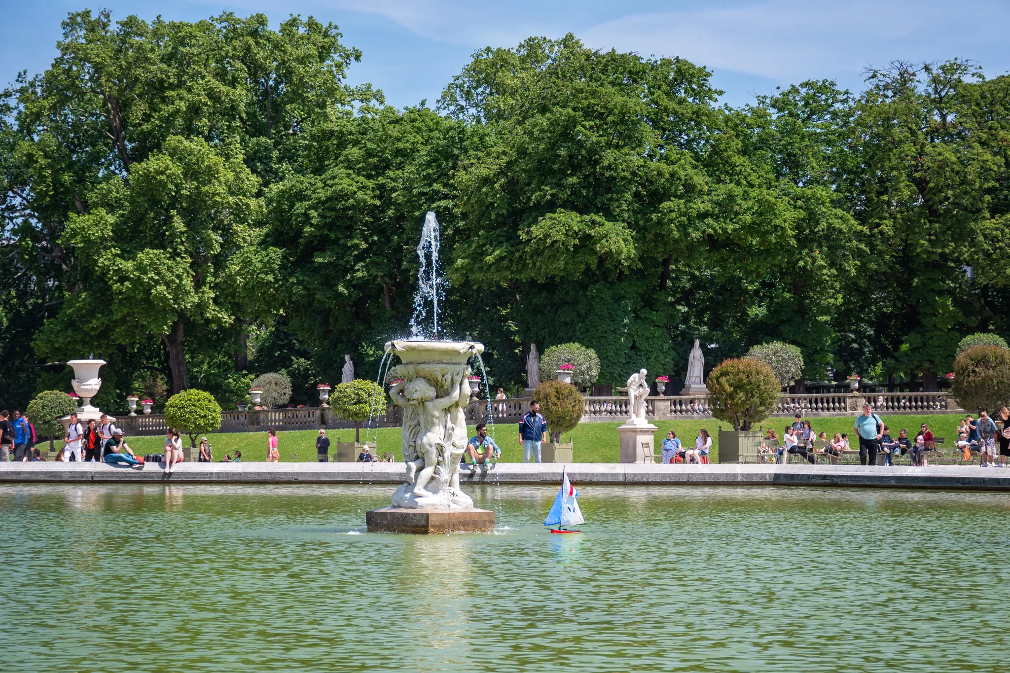 Lake with little toy sailboats at Luxembourg Gardens Paris