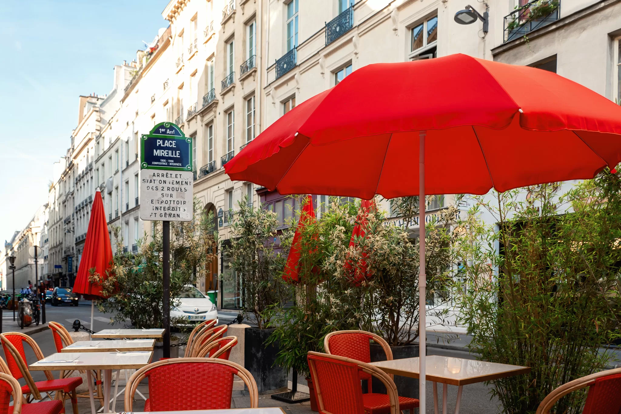 Red umbrellas at a cafe on rue de richelieu in Paris near our Paris Airbnb