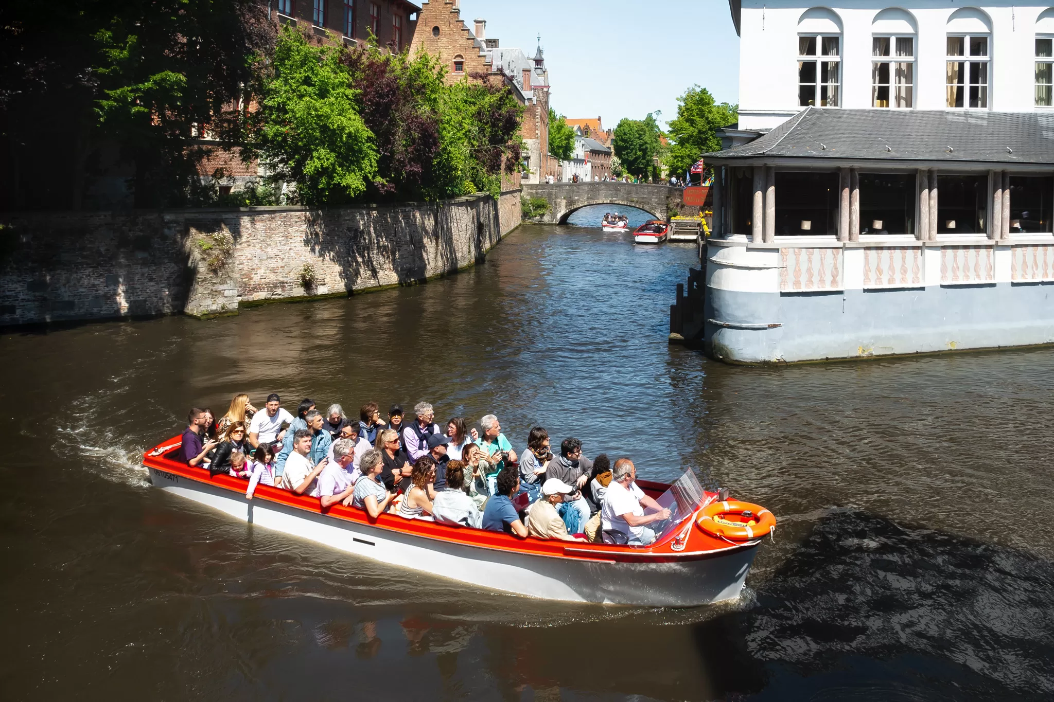 A full canal tour boat ride in the water in Brugges Belgium