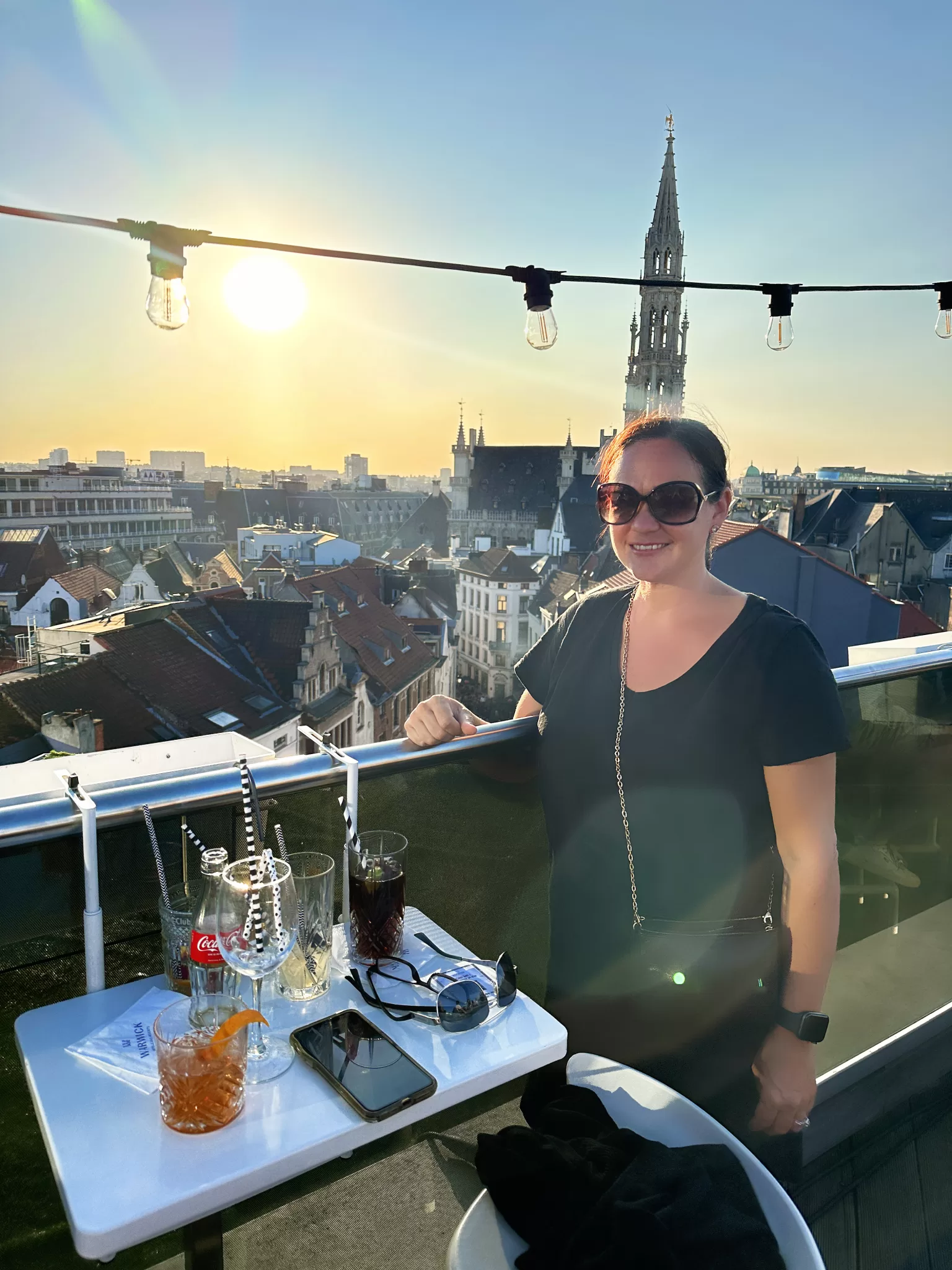 woman standing on the roof at sunset at the Secret Rooftop Bar Brussels