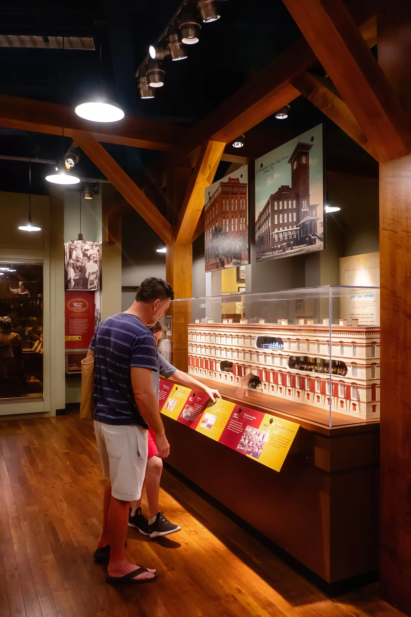 a father and son reading a display about cigars in Ybor city and a Tampa history timeline