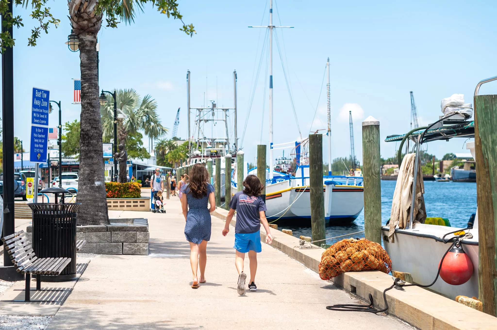 This image is for a blog post about Tarpon Springs Florida and shows a boy and girl walking downtown hear the sponge docks.