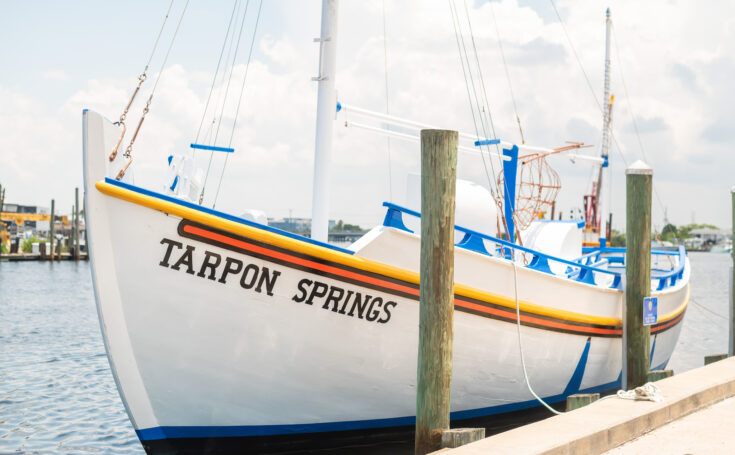 This image is for a blog post about Tarpon Springs Florida and shows a Greek Sponge Boat that says TARPON SPRINGS on it