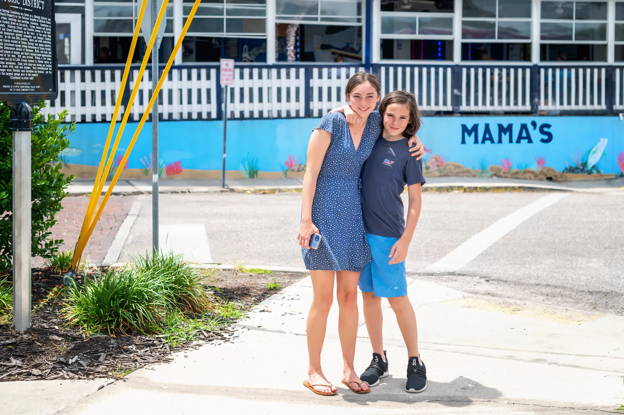 Two kids in front of a greek restaurant in Tarpon Springs florida.