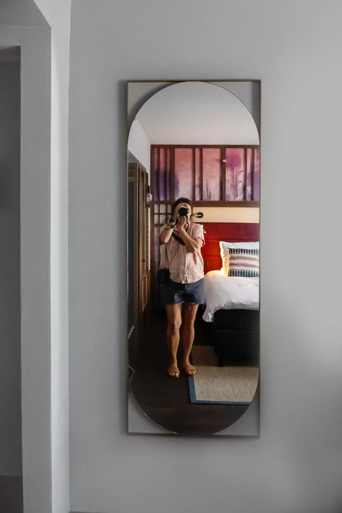 Woman taking a photo of herself in the mirror the Hotel Indigo Brussels City in Belgium Europe.