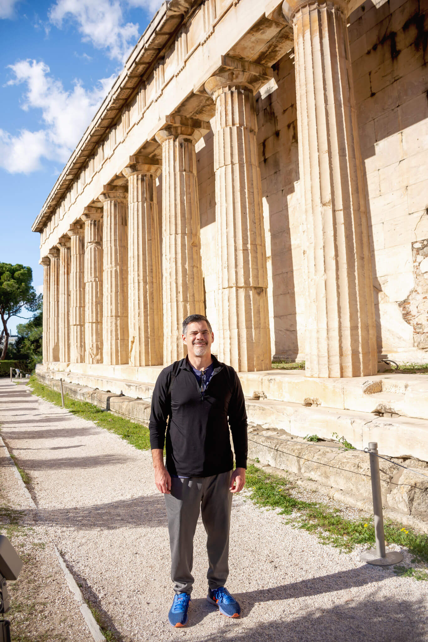 Man standing near the temple at the Ancient Greek Agora