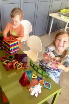 Two kids playing with magformers