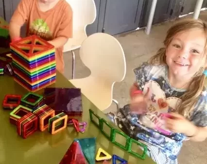 Two kids playing with magformers