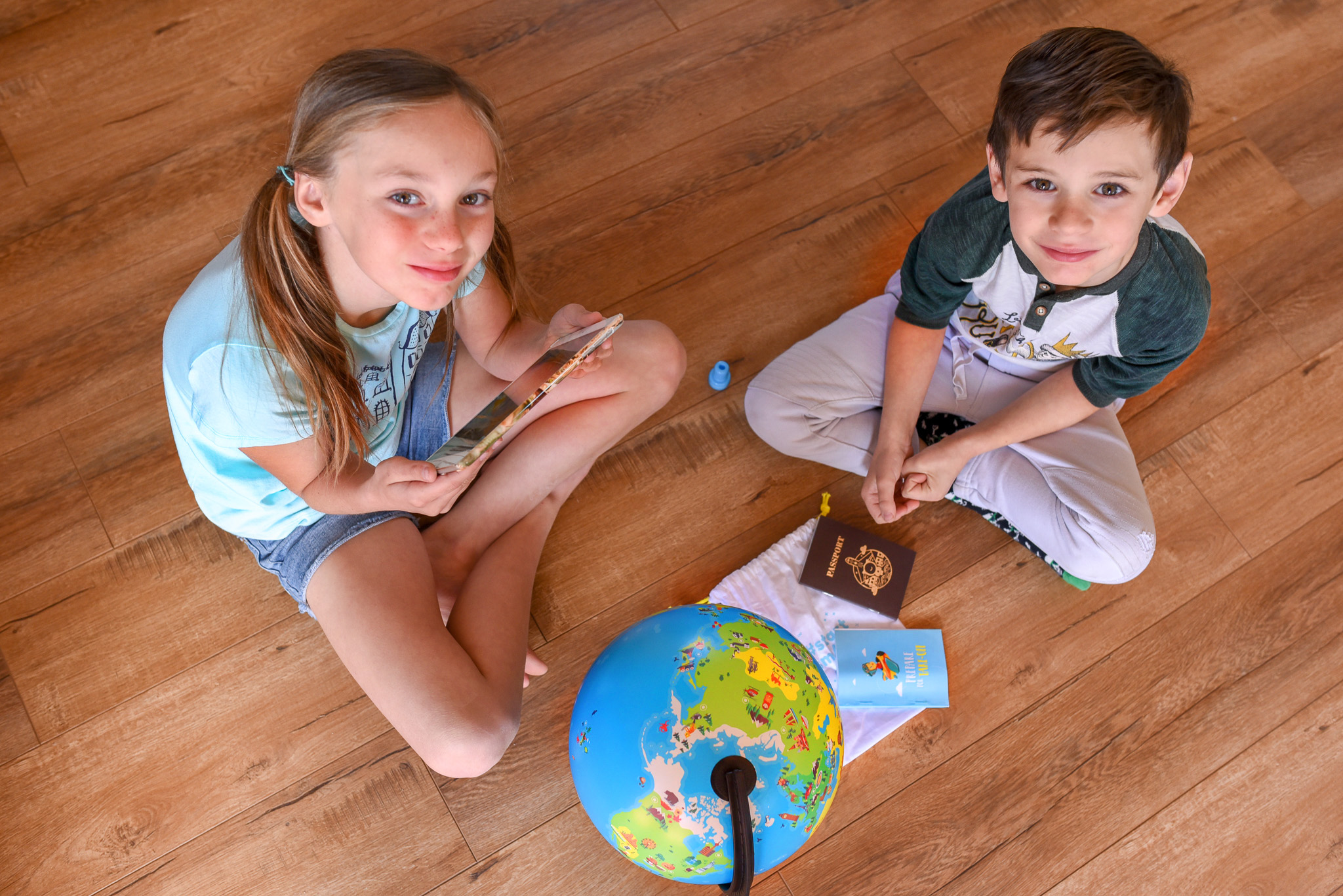 Two kids playing with the Shifu Orboot Educational Globe 