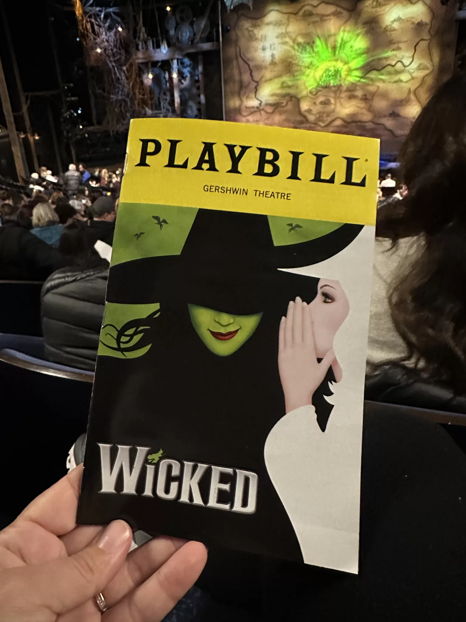 a photo of the Wicked on Broadway playbill held at a show