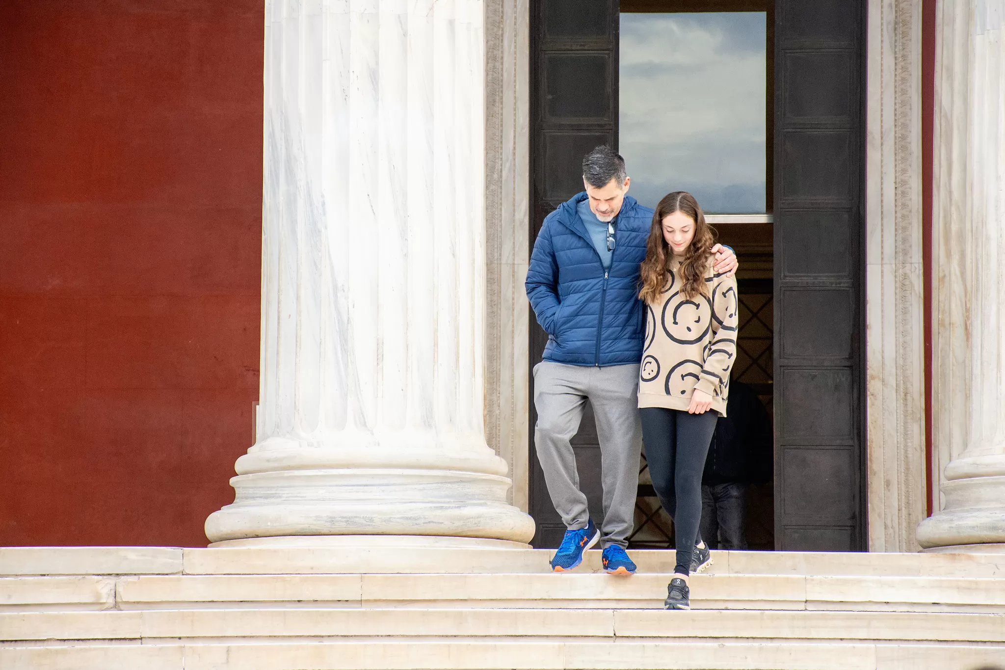 A father and daughter leaving a museum in Athens, Greece.