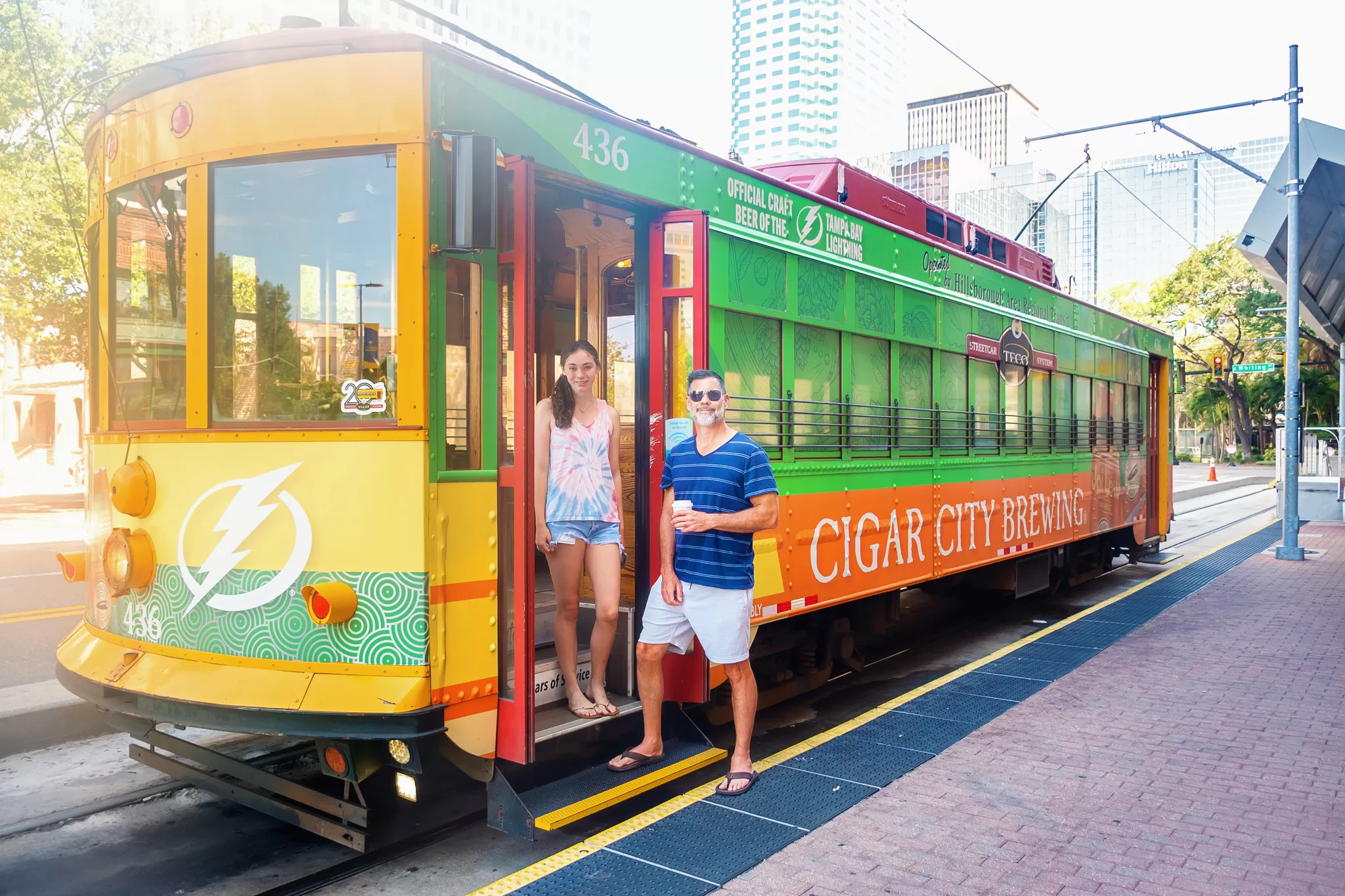 A father and daughter boarding a free streetcar in tampa
