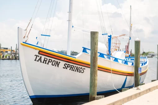 This image is for a blog post about Tarpon Springs Florida and shows a Greek Sponge Boat that says TARPON SPRINGS on it