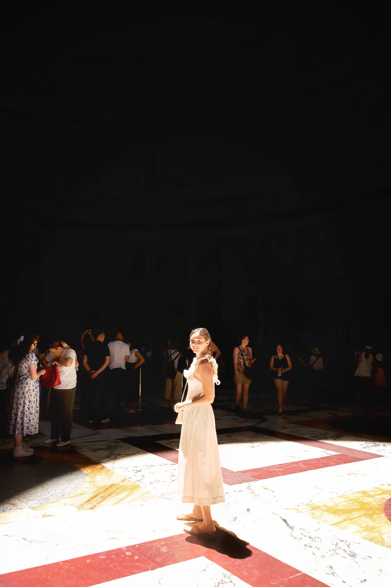 A girl in the light of the oculus at the Pantheon Rome Italy 