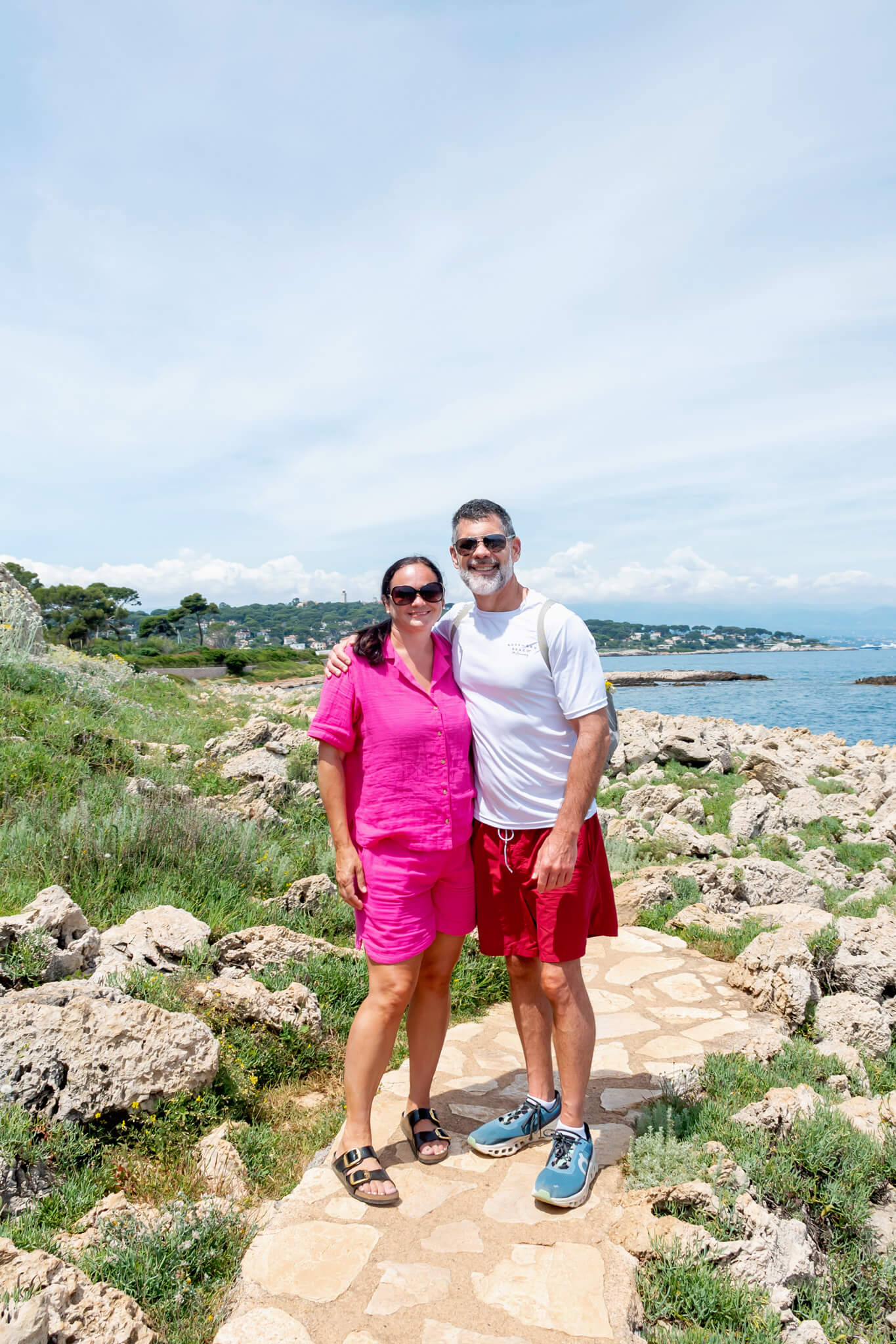 A husband and wife hiking trail along the Cap d'Antibes Hike in Antibes France