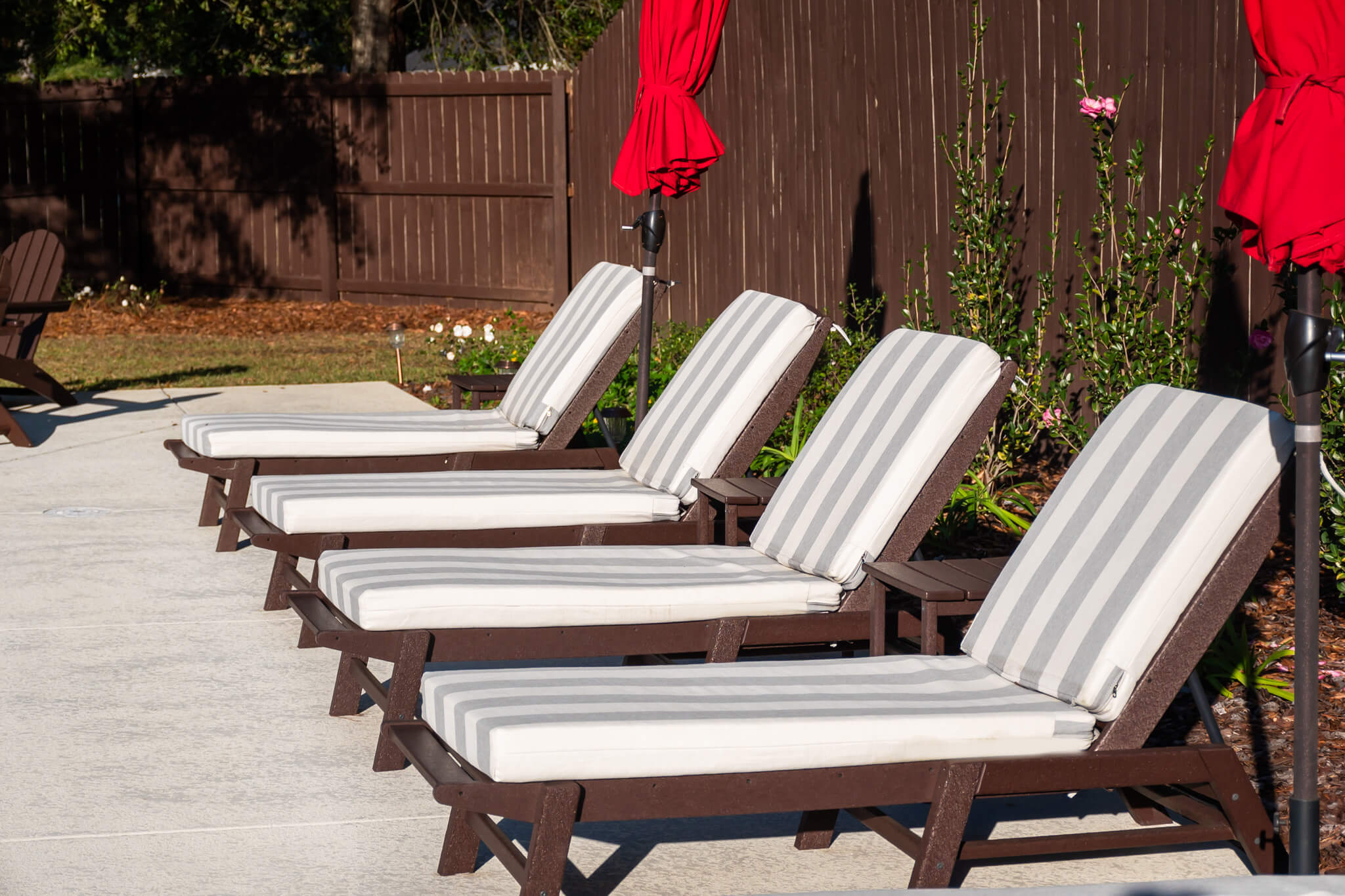 Backyard Furniture From Wayfair feat Polywood loungers and cushions