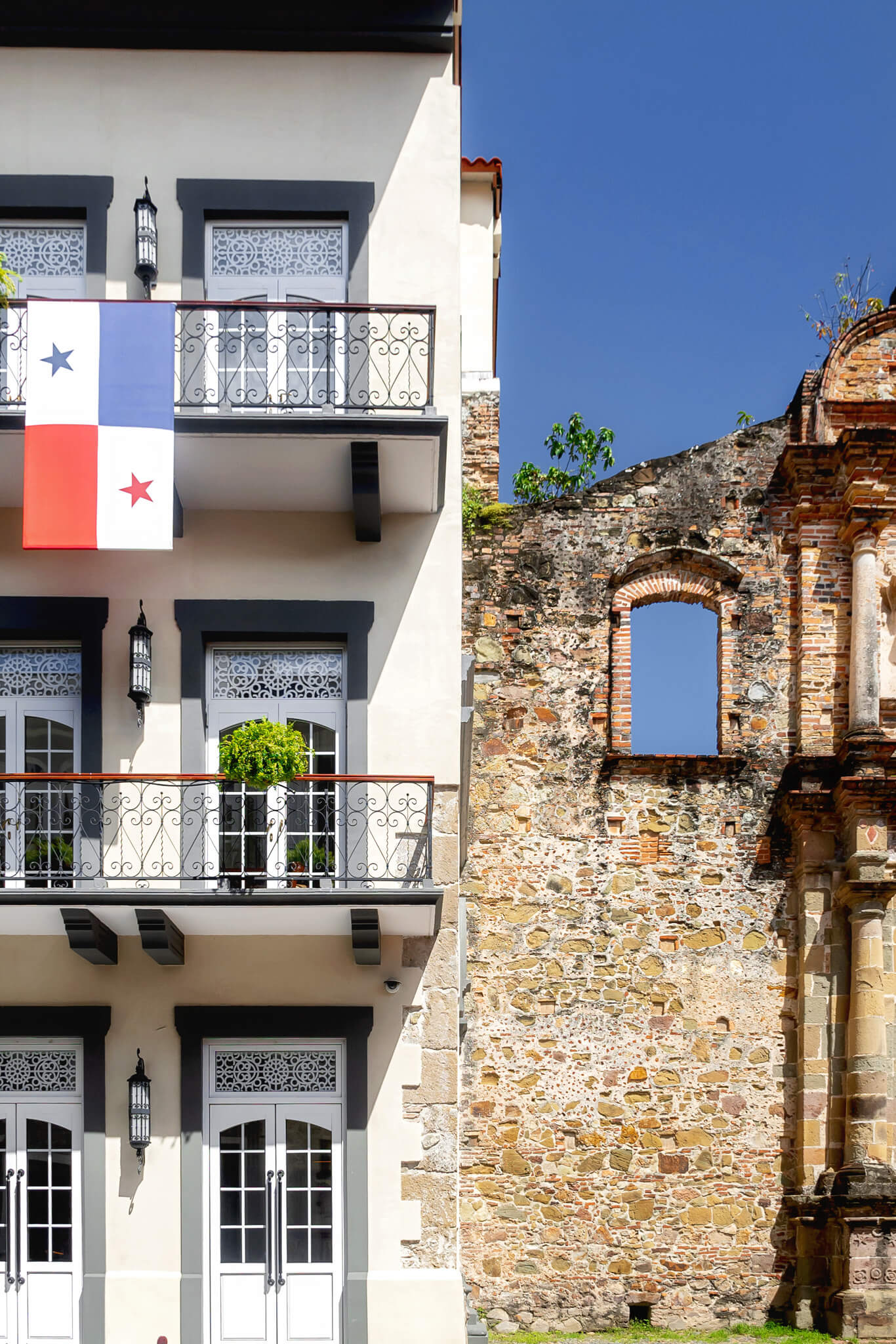 old building next to a new building in Casco Viejo Panama City Old Town